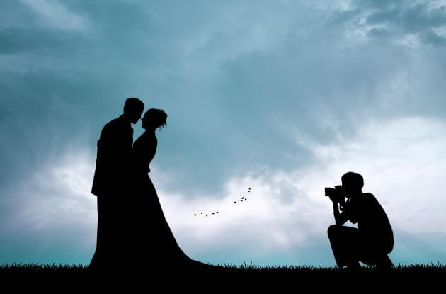 wedding photographer taking picture at dusk