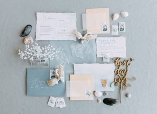 Wedding invitation cards and envelopes arranged with flowers
