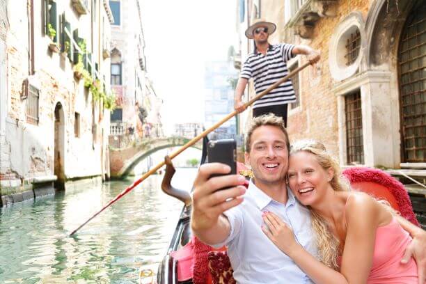 Perfect Luxury Honeymoon Destinations Around the World 4 A couple on a gondala in Venice, Italy