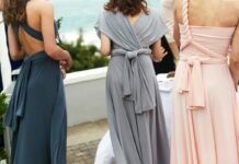 Three bridesmaids wearing different blue, grey and blush dress styles